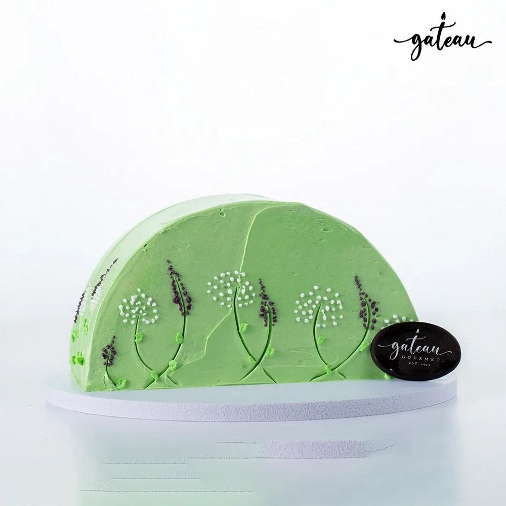 Gateau Gourmet Cafe green cake decorated with dandelion-lavender-flower design on frosting