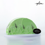 Gateau Gourmet Cafe green cake decorated with dandelion-lavender-flower design on frosting