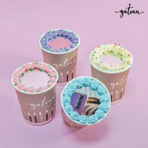 Set of four decorative cake cups from Gateau Gourmet Cafe with colorful frosting designs