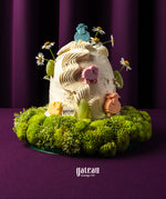 Gateau Gourmet Cafe Eid Al Adha cake ideas with white frosting, colorful sheep decorations, and green floral base