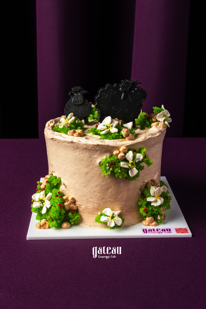 Gateau Gourmet Cafe Eid Al Adha cakes with decorative sheep and floral green frosting on cream cake
