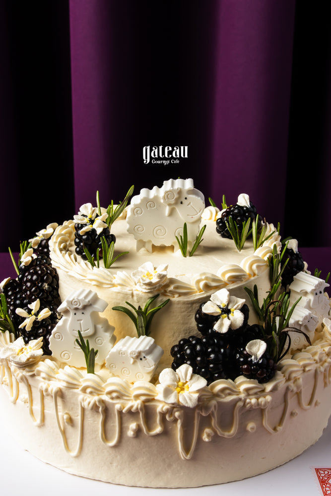 Gateau Gourmet Cafe Eid Al Adha cakes delivery decorated with creamy white frosting blackberries and sheep-shaped fondant