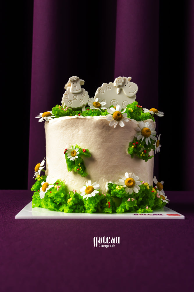 Gateau Gourmet Cafe Eid Al Adha cakes with white frosting decorated with green icing and sheep toppers