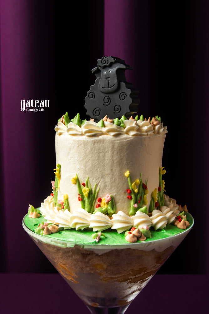 Eid Al Adha cakes by Gateau Gourmet Cafe featuring a decorated cake with a black sheep topper and floral icing