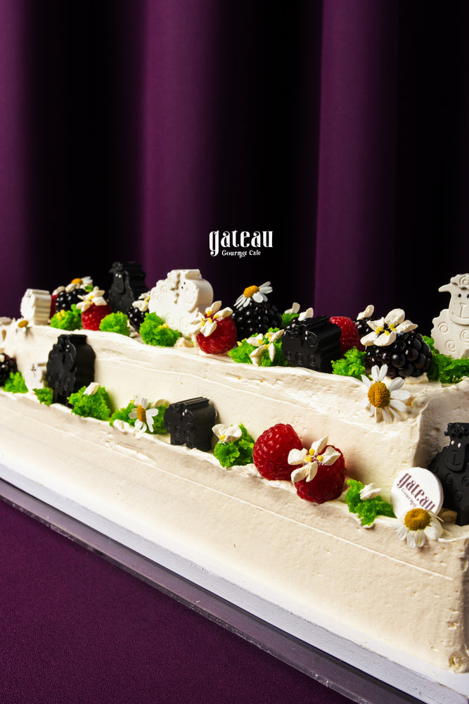 Gateau Gourmet Cafe cake decorated with berries herbs and flowers for Eid celebration desserts
