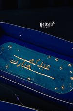Eid loaf cake from Gateau Gourmet Cafe with elegant gold decoration on a blue background