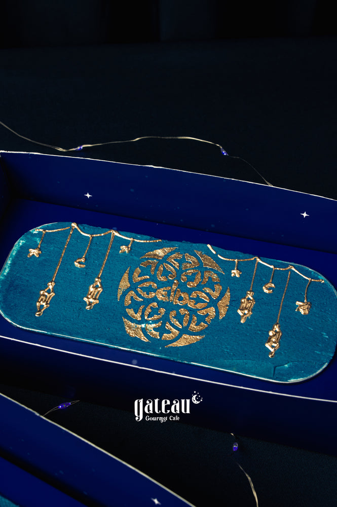 Elegant eid-loaf-cake from Gateau Gourmet Cafe with intricate gold designs on a blue background