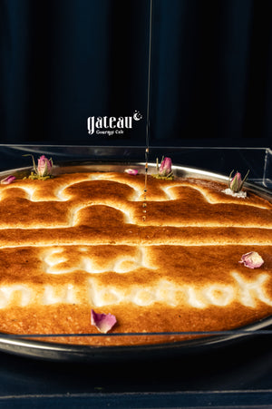 Delicious Eid Mubarak basboosa cake decorated with rose petals and intricate designs
