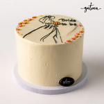 Elegant bridal party cake with simple cream frosting and floral decorations by Gateau Gourmet Cafe