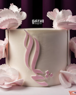 Embossed wedding cake design with delicate pink floral accents by Gateau Gourmet Cafe