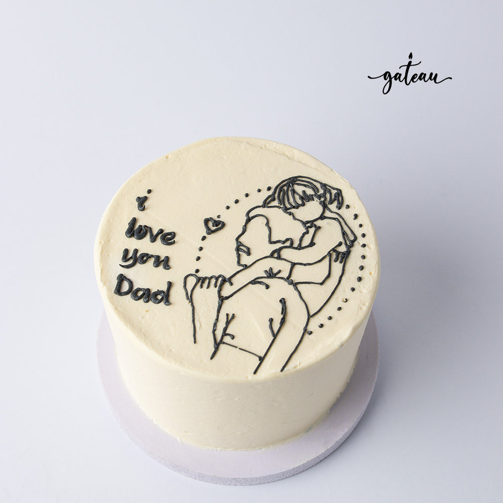 Father's Day cake from Gateau Gourmet Cafe with white frosting and black icing art of dad and child hugging