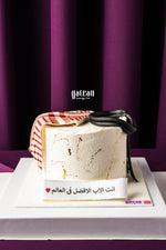 Gateau Gourmet Cafe Father's Day cake with white frosting and fondant accessories on white base