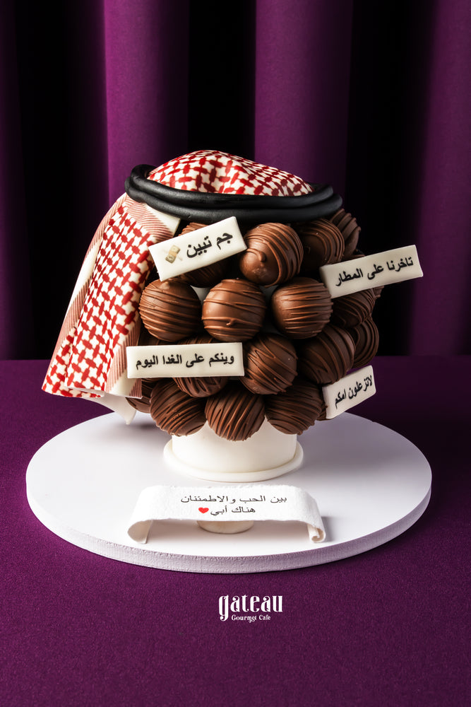 Father's Day chocolate truffles cake from Gateau Gourmet Cafe decorated with a red and white patterned headdress