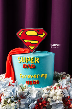 Father's Day mini cake by Gateau Gourmet Cafe with Superman logo and red cape decoration