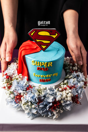 Father's Day mini cake by Gateau Gourmet Cafe decorated with Superman logo and red cape