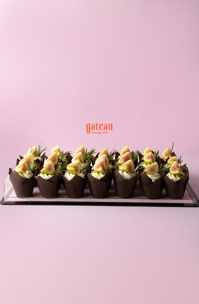 Delicious fig cupcake topped with creamy frosting and garnished with fresh figs at Gateau Gourmet Cafe