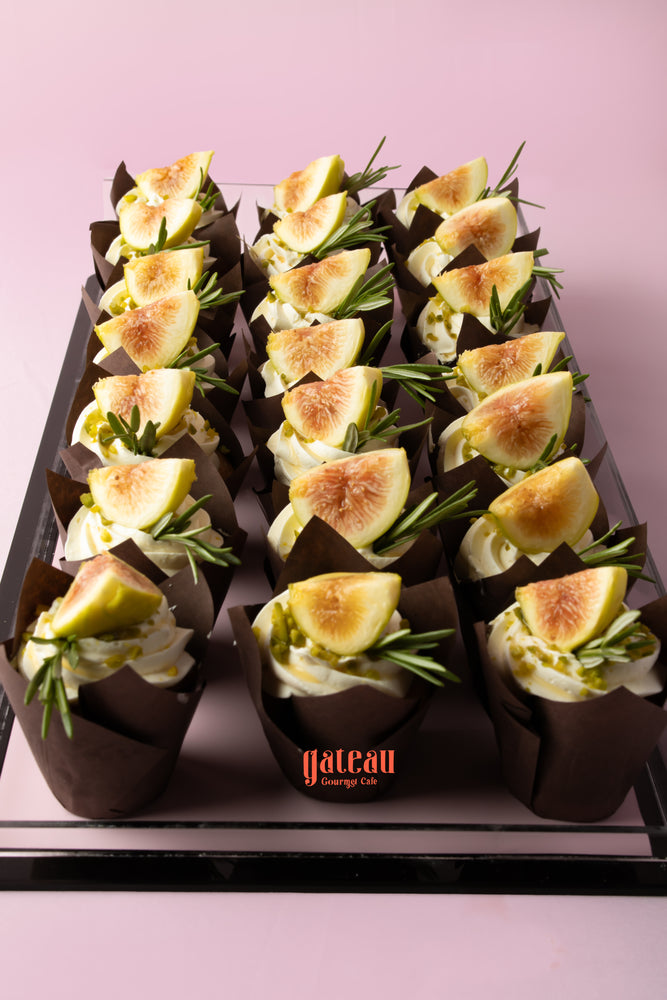 Delicious fig cupcake topped with fresh figs and cream, beautifully presented at Gateau Gourmet Cafe