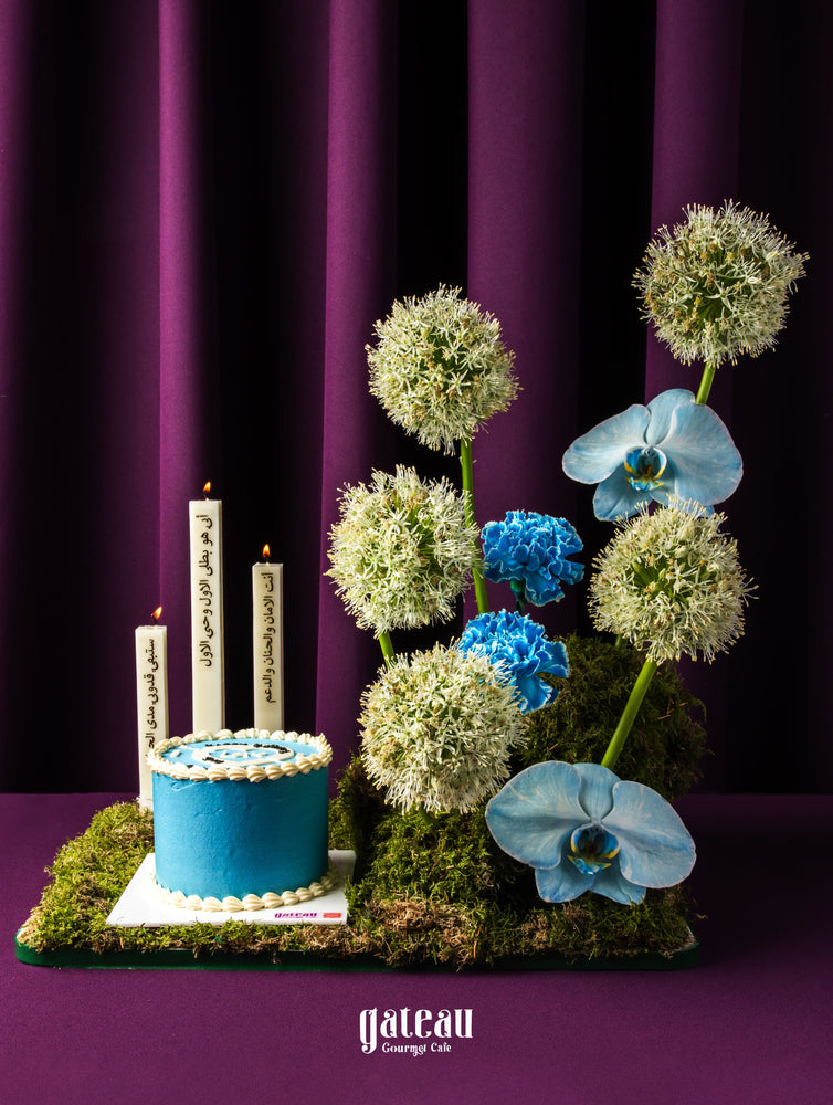 Floral cake arrangement for dad with blue cake and white flowers by Gateau Gourmet Cafe