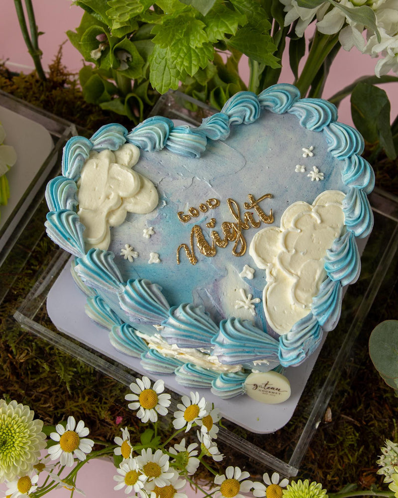 Gateau Gourmet Cafe heart-shaped cake with blue and white floral cake arrangements and good night decoration