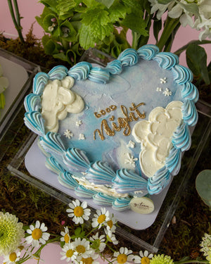 Gateau Gourmet Cafe heart-shaped cake with blue and white floral cake arrangements and good night decoration