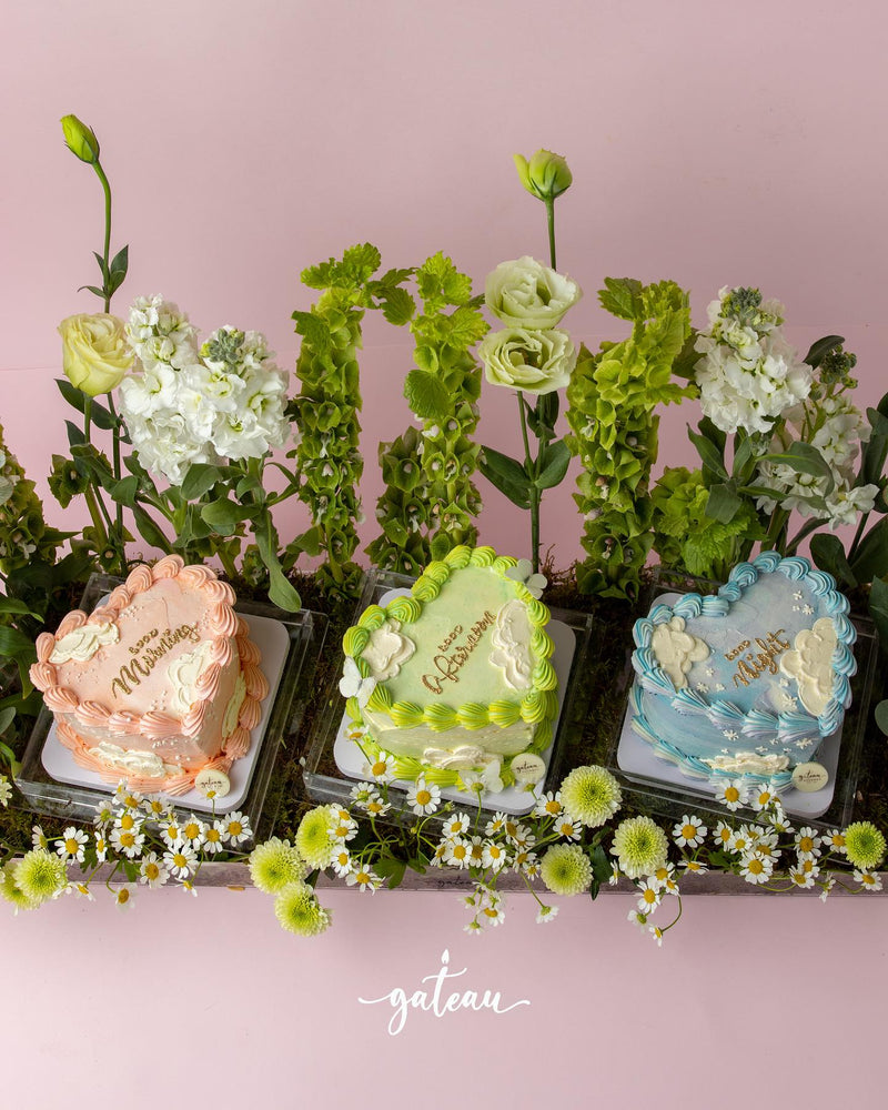 Gateau Gourmet Cafe heart-shaped cakes with floral cake arrangements in pastel pink green and blue designs