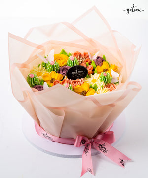 Floral cake decoration bundle from Gateau Gourmet Cafe featuring colorful buttercream flowers wrapped in translucent pink paper