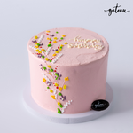 Pink flower bundle cake decorated with colorful icing flowers and 'Happy Birthday' message
