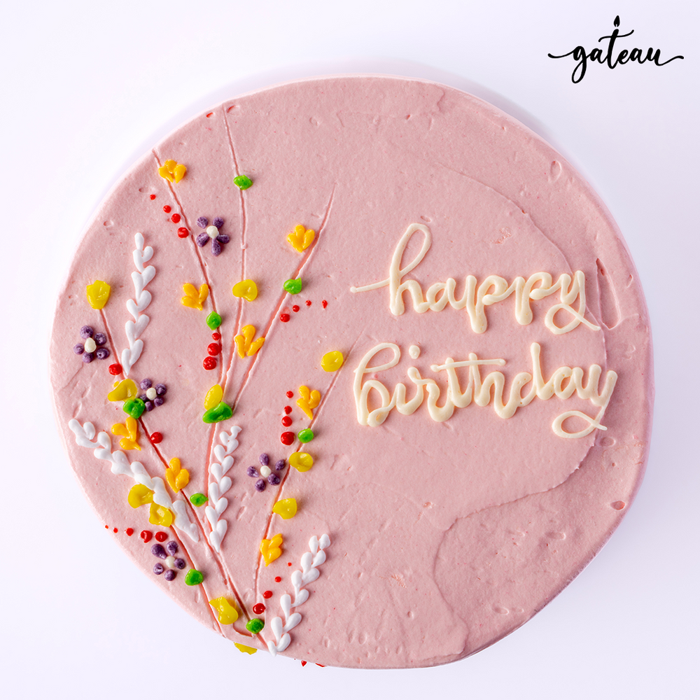 Flower bundle cake with pink frosting and colorful floral decorations for birthdays