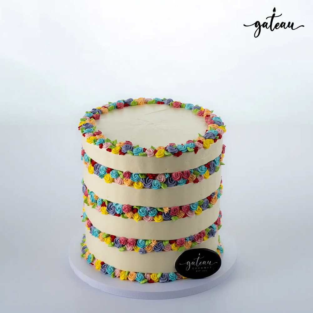 Three-tier flower-fault-line cake decorated with colorful buttercream rosettes from Gateau Gourmet Cafe