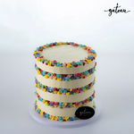Three-tier flower-fault-line cake decorated with colorful buttercream rosettes from Gateau Gourmet Cafe