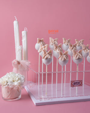 Gateau Gourmet Cafe pink fondant cakes for celebrations shaped as cake pops with bows on a clear stand