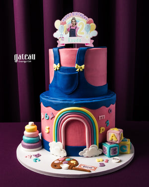 Colorful fondant rainbow cake with playful decorations for a joyful birthday celebration
