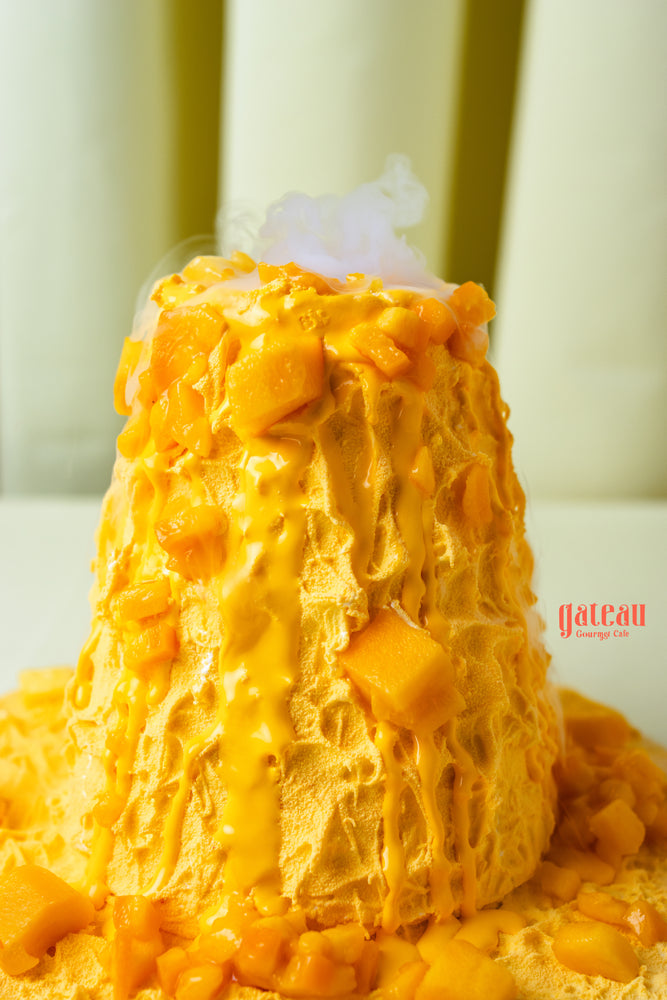 Fresh mango layered cake from Gateau Gourmet Cafe with mango chunks and creamy sauce