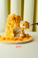 Fresh mango layered cake from Gateau Gourmet Cafe with creamy mango topping and soft sponge layers