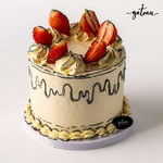 Gateau Gourmet Cafe fresh strawberry cake with creamy frosting and topped with sliced strawberries