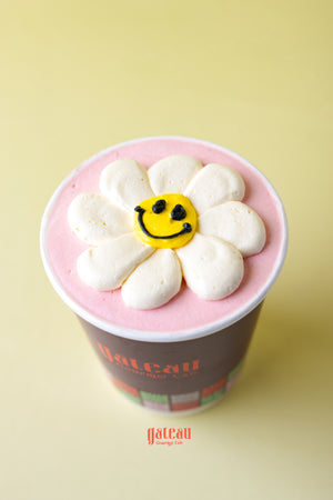 Fruit decorated cupcakes for parties with white petals and yellow smiley face frosting from Gateau Gourmet Cafe