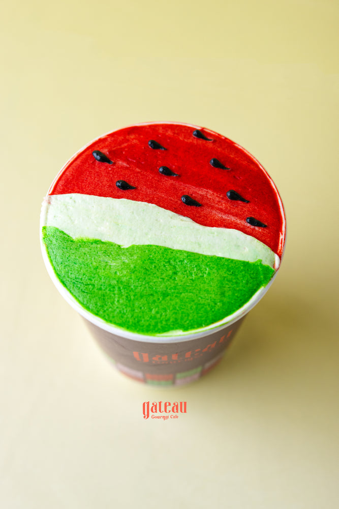 Fruit decorated cupcakes for parties by Gateau Gourmet Cafe featuring watermelon design with red, white, and green frosting