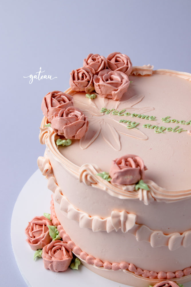 Elegant cake with full-bloom-rose-design and delicate pink frosting flowers for celebrations