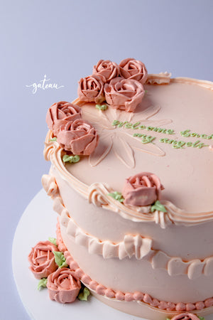 Elegant cake with full-bloom-rose-design and delicate pink frosting flowers for celebrations