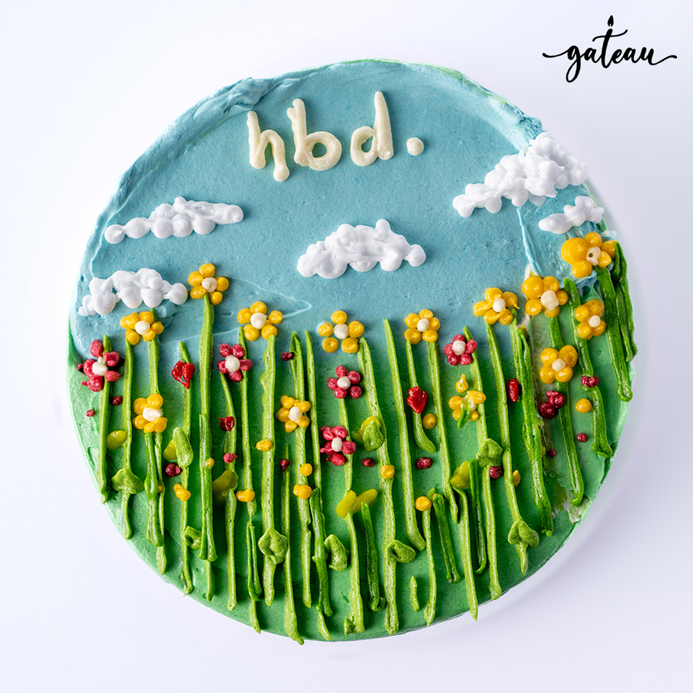 Colorful garden flowers Cake with blue sky and frosting clouds, perfect for birthday celebrations