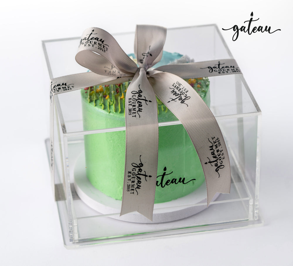 Gateau Gourmet Cafe garden flowers Cake in a clear box with elegant ribbon and vibrant floral decoration