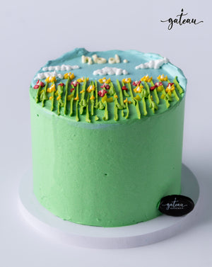 Garden flowers Cake decorated with vibrant icing flowers and a blue sky design on top