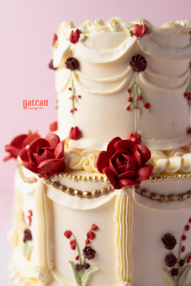Beautiful Garden of Memories cream cake decorated with red roses and intricate piping details