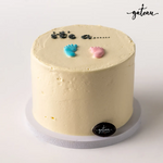 Delicious Gender Reveal Cake with pastel foot designs and text detailing for celebrations
