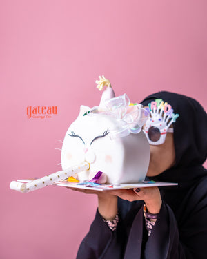 Gibbous Cake for celebrations from Gateau Gourmet Cafe shaped like a cat with party decorations