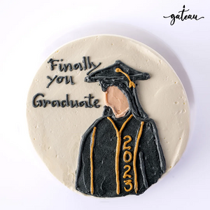 Gild graduation celebration cake decorated with a graduate figure and 2023 text
