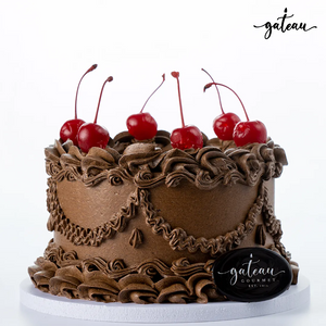 Gateau Gourmet Cafe gourmet chocolate delight cake decorated with chocolate frosting and fresh cherries
