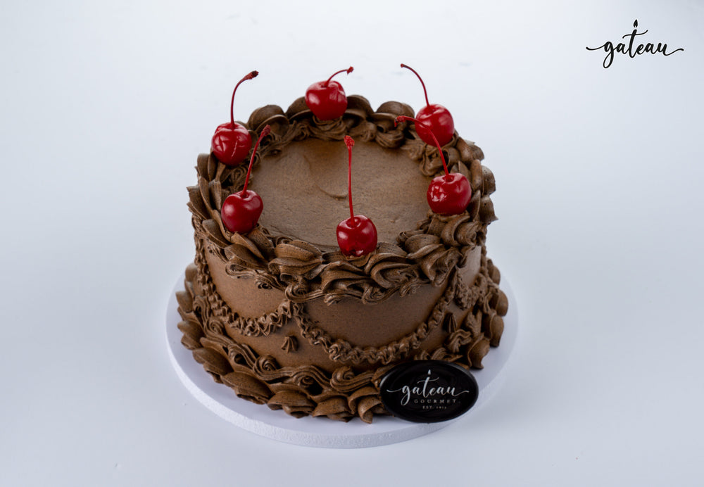 Gateau Gourmet Cafe gourmet chocolate delight cake decorated with chocolate frosting and cherries