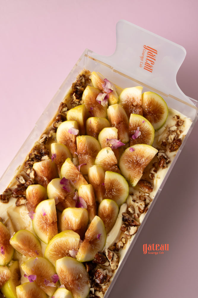 Delicious gourmet fig cake for special occasions topped with fresh figs and floral accents