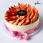 Gourmet strawberry cheesecake topped with fresh sliced strawberries and decorated with pink ribbon